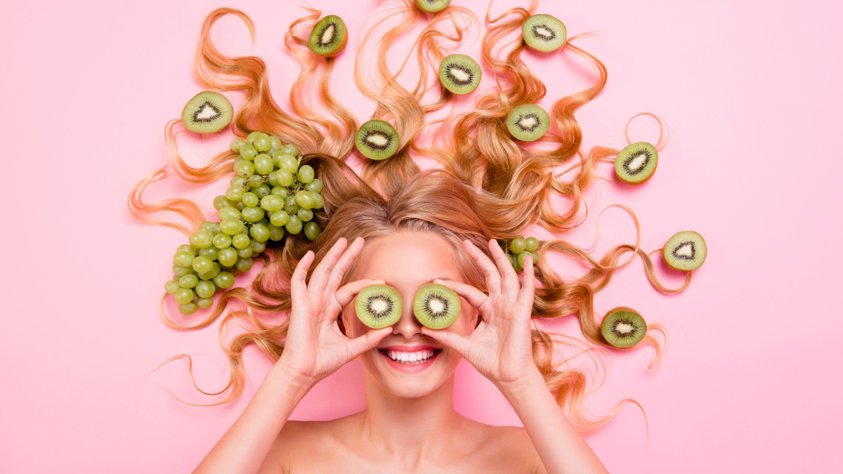 Smiling woman with antioxidant foods in her hair