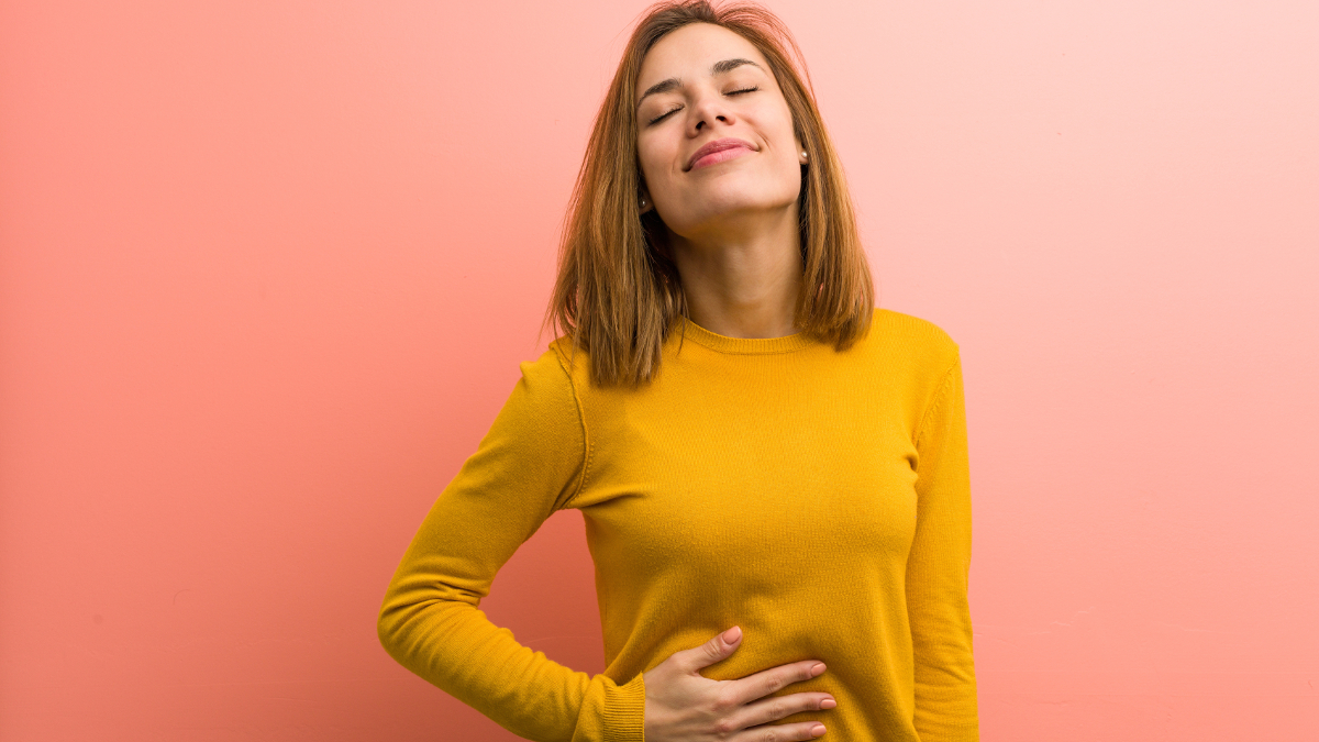 Mujer aliviada que digiere la comida